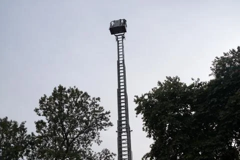 Retractable fire stairs on the background of trees close up Stock Photos