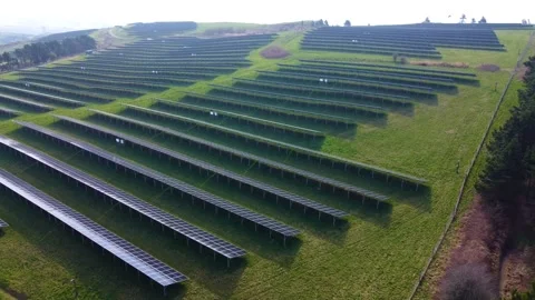 Retreating Aerial of Modern solar panel array on hilltop in UK Stock Footage 332627041