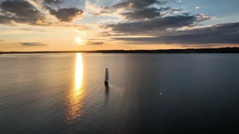 Retreating shot, pulling away from sailboat with white sail. Stock Footage 287567876