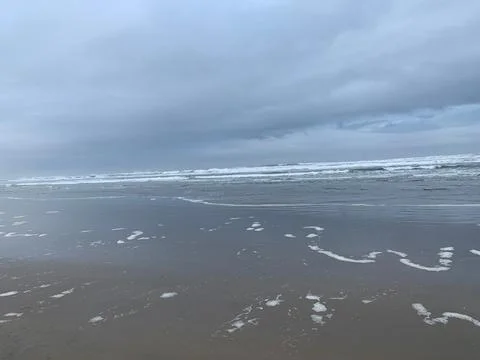 Retreating waves view of beach 写真素材
