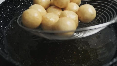 Retrieving meat ball from the frying pan Stock Footage 247827631