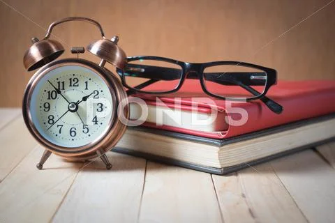 Retro alarm clock and book. Stock Photos