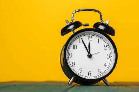 Retro alarm clock on table. Close up. Stock Photos