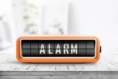 Retro alarm clock with a warning message on a table Stock Photos