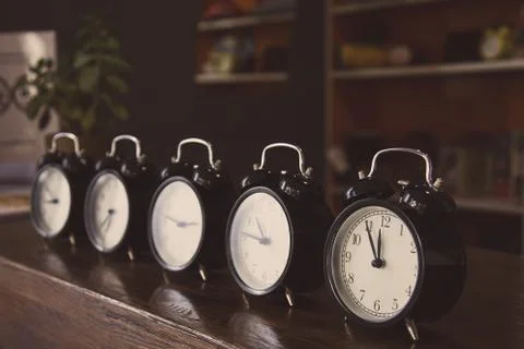 Retro alarm clocks on the table. Stock Photos