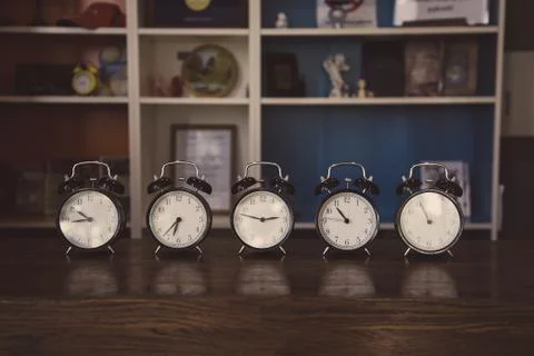 Retro alarm clocks on the table. Photos