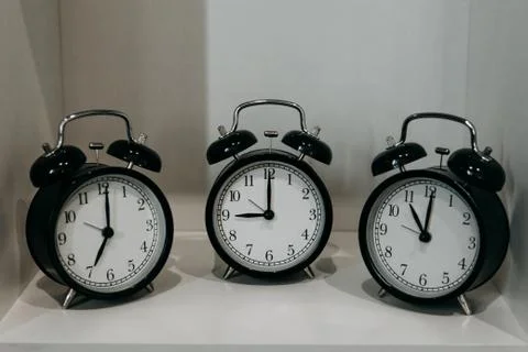 Retro alarm clocks on the table. Stock Photos