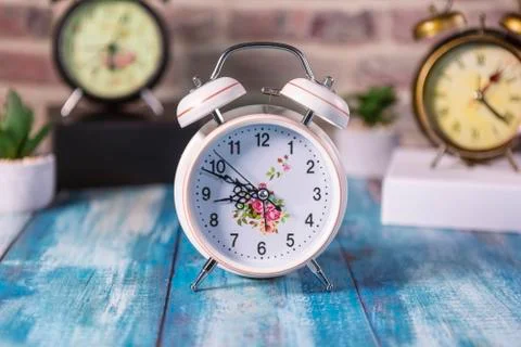 Retro alarms clock on a table. 스톡 사진