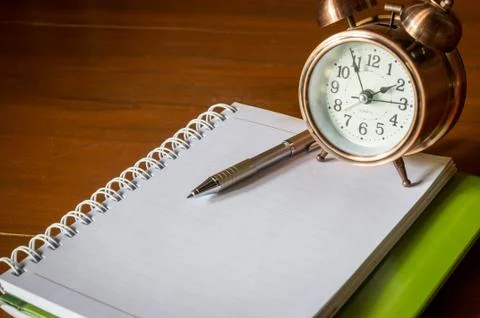 Retro alarrm clock with book. Stock Photos