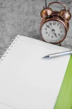 Retro alarrm clock with book. Stock Photos