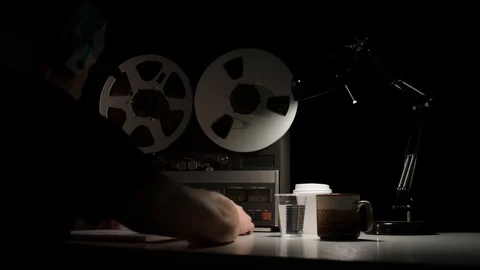 Retro Analog Quarter Inch Reel-To-Reel Recorder Being Operated in Dark Room Stock Footage 117911038