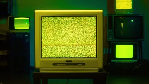 Retro analog television sets displaying green static noise in studio Stock-Footage 341801693