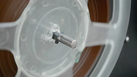 Retro audio tape bobbin rotation, vintage tape recorder, record player closeup. Stock Footage 232640539