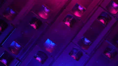 Retro background of VHS cassettes sliding right, blue and purple light, top view Stock Footage 155883551
