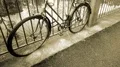 Retro bicycle standing near river tied to fence, vintage old fashioned vehicle 4k or 4k+ Resolution