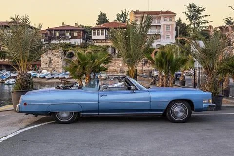 Retro blue convertible Cadillac Eldorado on port of Nessebar at sunset Stock-Fotos