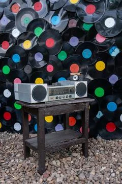 Retro Boombox and Antique Camera on Wooden Stool with Vinyl Background Photos