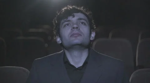 Retro boy is sitting alone in the cinema and watching movie Stock Footage 54245861