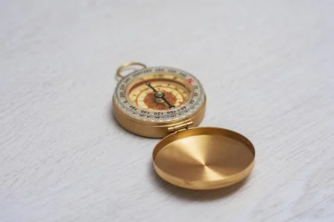 Retro brass compass in large. Navigation tool for tourism. Stock Photos