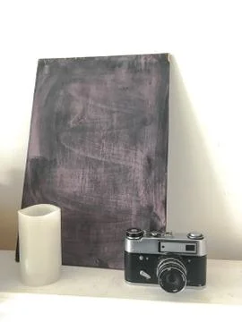 Retro camera and candle on the table Foto stock