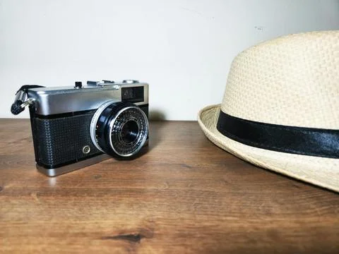 Retro camera and straw hat Stock Photos
