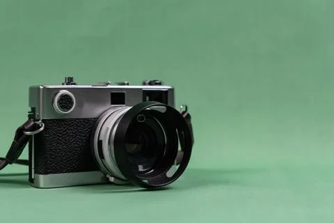 Retro camera with copy space on green background Stock Photos