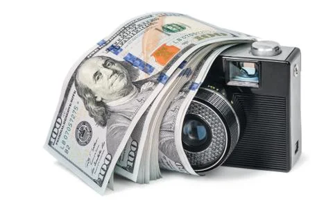 Retro camera with dollars Stock Photos
