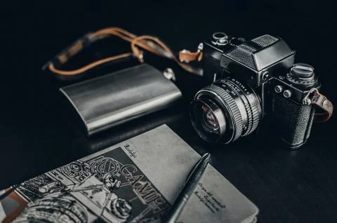 Retro Camera With Notebook On Dark Background Foto stock