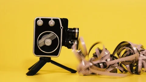 Retro camera. Retro camera and movie film on which the camera shoots. Stock Footage 129409445