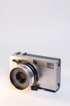 Retro camera with a silver body on a white background Foto stock