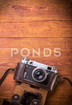 Retro camera on wood table background, vintage color tone Stock Photos