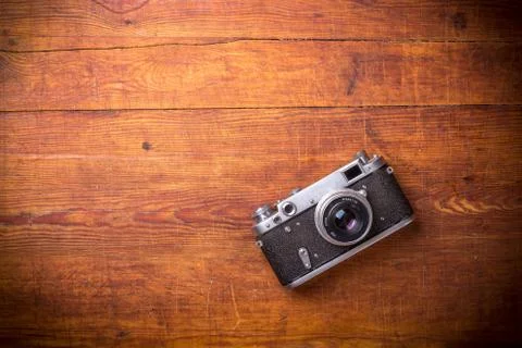 Retro camera on wood table background, vintage color tone Stock Photos