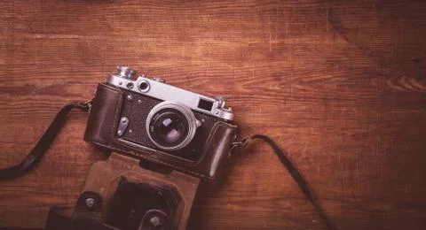 Retro camera on wood table background vintage color tone Stock Photos