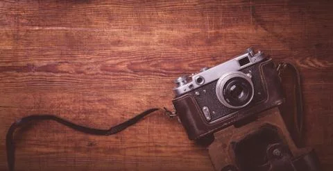 Retro camera on wood table background vintage color tone Stock Photos