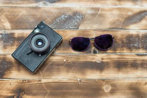 Retro camera on wood table background, vintage color tone Stock Photos