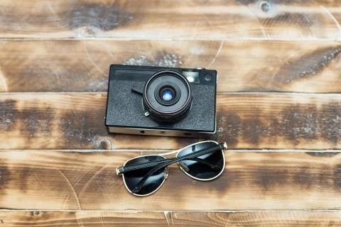 Retro camera on wood table background, vintage color tone Stock Photos