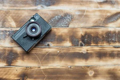 Retro camera on wood table background, vintage color tone Stock Photos