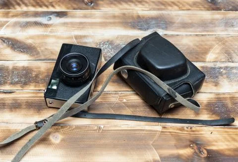 Retro camera on wood table background, vintage color tone Stock Photos