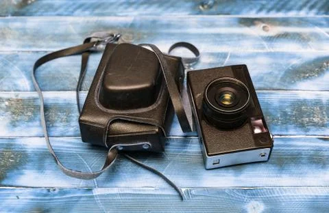 Retro camera on wood table background, vintage color tone Stock Photos