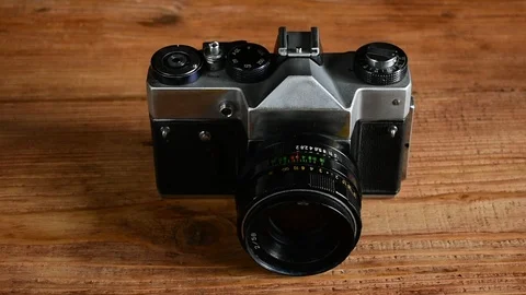 Retro camera on a wooden table Stock Footage 112922524