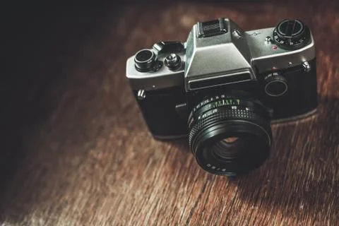 Retro camera on wooden table Stock Photos