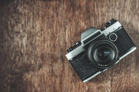 Retro camera on wooden table Stock Photos