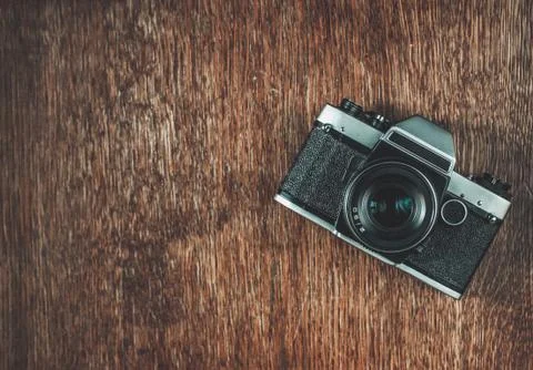 Retro camera on wooden table Stock Photos