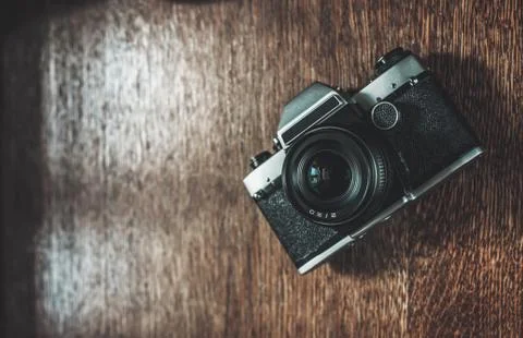 Retro camera on wooden table Stock Photos