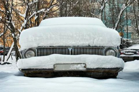 Retro car covered with a thick layer of snow 写真素材