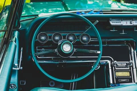 Retro car dashboard interior. View of the steering wheel and dashboard of an  Stock Photos