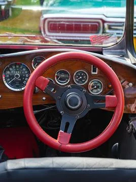 Retro car dashboard interior. View of the steering wheel and dashboard of an old Stock Photos