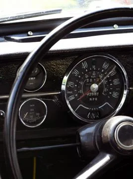 Retro car dashboard interior. View of the steering wheel and dashboard of an  Stock Photos