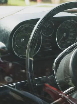 Retro car dashboard interior. View of the steering wheel Stock Photos