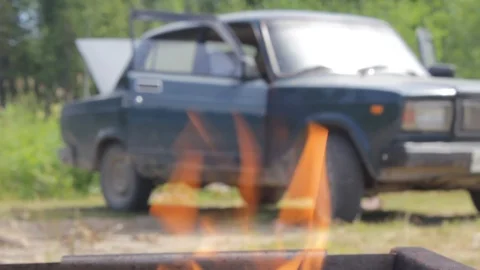Retro car in the forest. A view from the fire of the barbecue. Stock-Footage 92951197